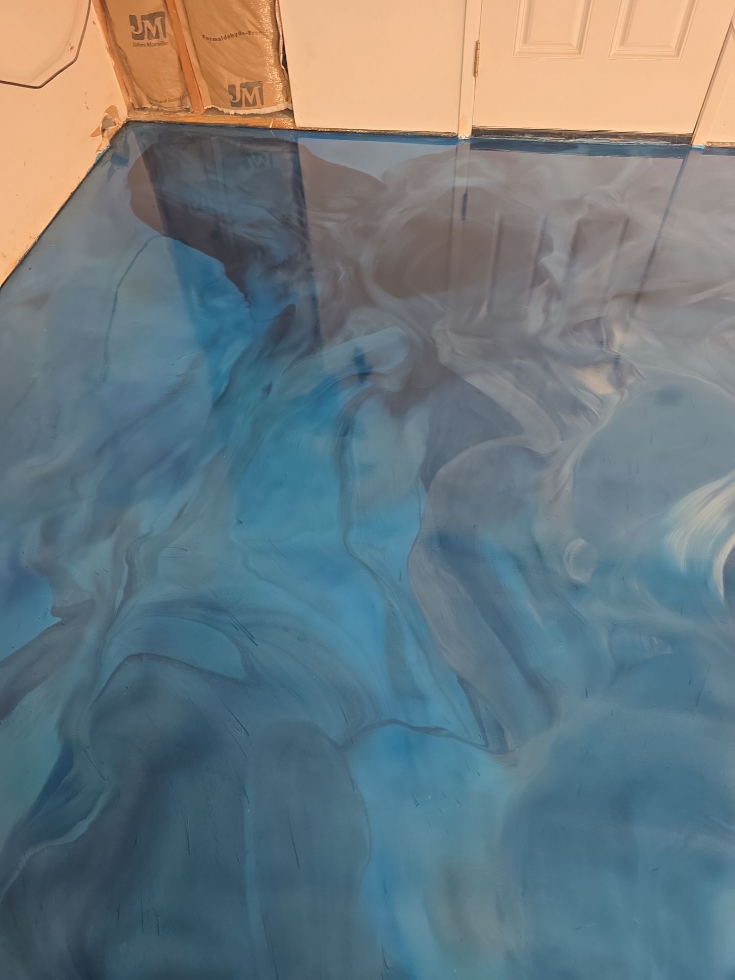 Swirling blue metallic epoxy floor detail