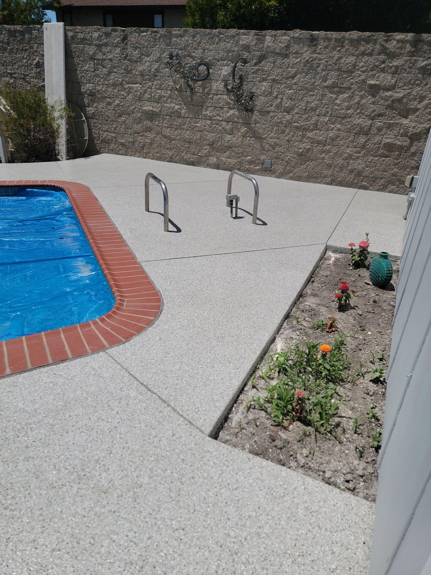 Pool deck surrounding backyard pool